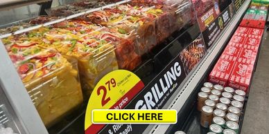 Packaged grilled chicken with price tags in a supermarket refrigerated display.