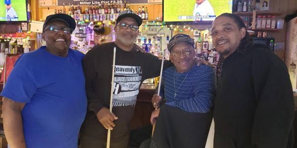 Happy four friends looking ahead together