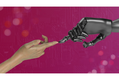 Image of a hand touching a robot's hand. 