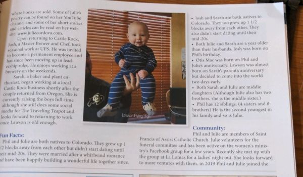 A baby named Lawson in striped clothes being held up indoors.