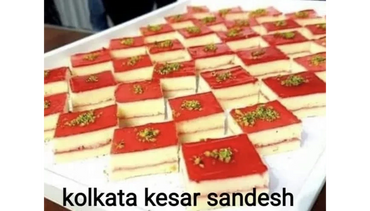 Slices of Kolkata Kesar Sandesh dessert with red topping and pistachio garnish.