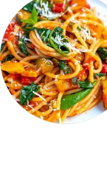 Plate of spaghetti with spinach, bell peppers, and grated cheese.