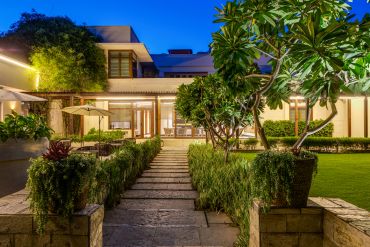 Modern house with garden at dusk.