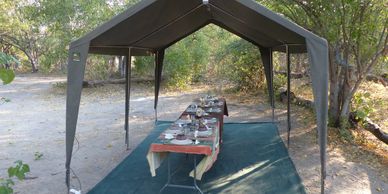 Outdoor dining setup under a canopy.