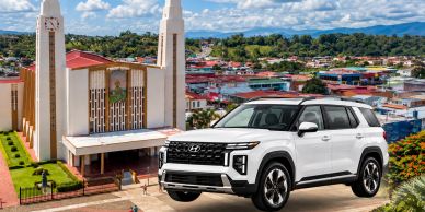 White SUV parked in front of a church.