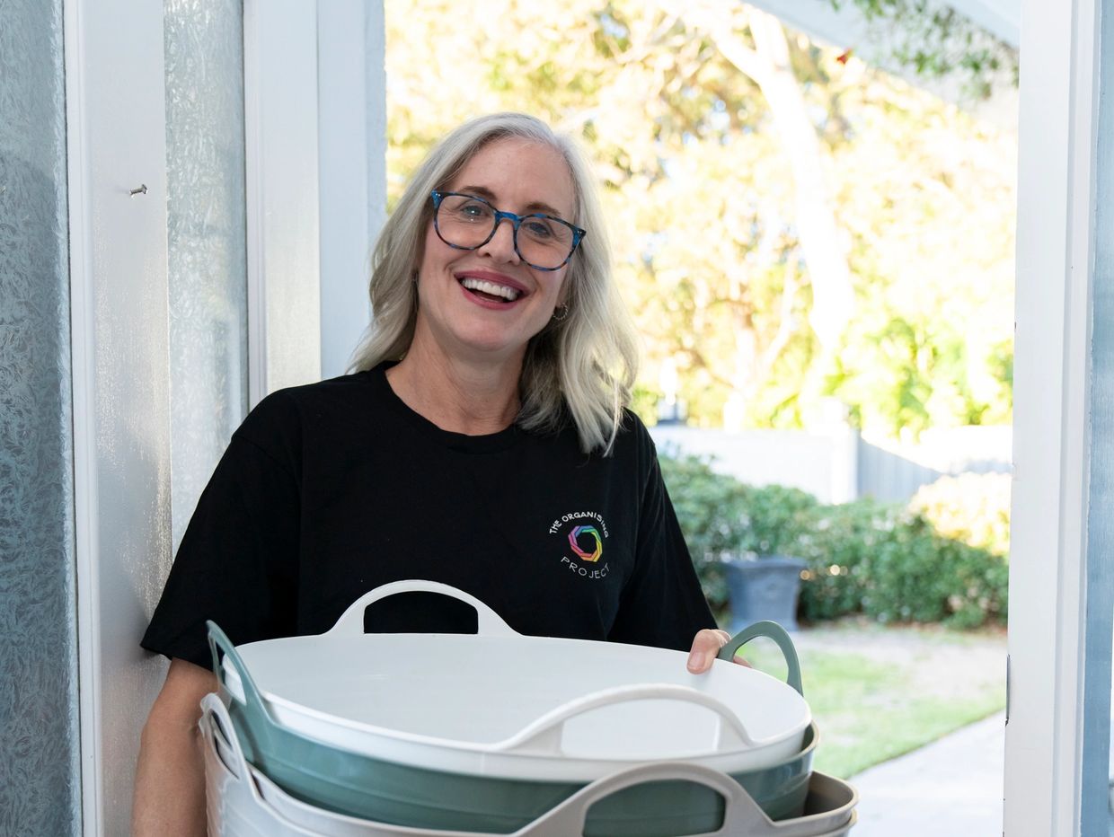 Christina carrying sorting tubs