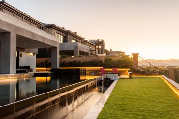 Modern house with pool and sunset view.