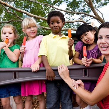 Children and teacher eating popsicles