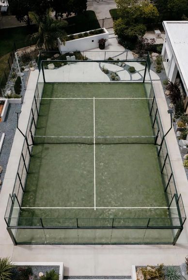 A private paddle tennis court in a residential backyard.