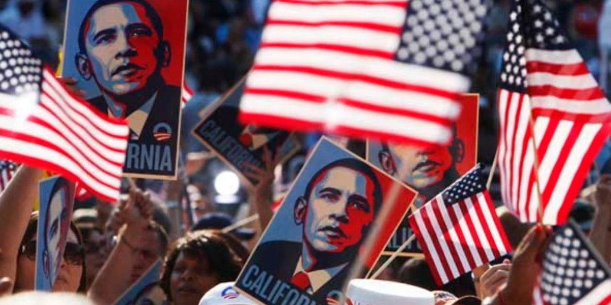 Crowd holding American flags and Obama posters.