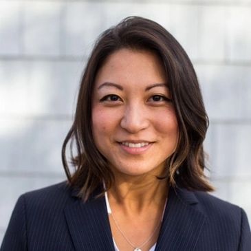Professional woman with a friendly smile in business attire.