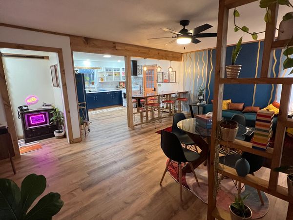 Living room with cafe table, bar top, and view of kitchen