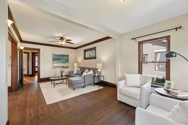 Cozy living room with wooden floors and neutral furniture.