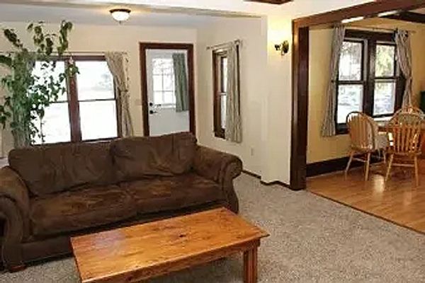 Cozy living room with brown sofa and wooden coffee table.