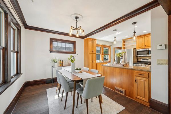 Bright dining area with wooden accents and modern kitchen.