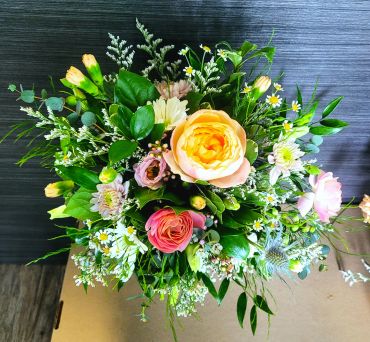 Colorful fresh flower bouquet with roses and greenery.