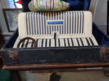 Vintage Wurlitzer accordion in its original case.