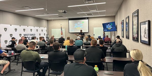 Police officers attending a training session in a West Fargo Police classroom.