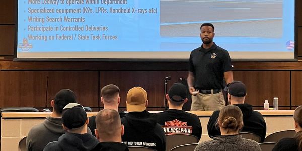 Instructor teaching a course on interdiction with focused students in a classroom.