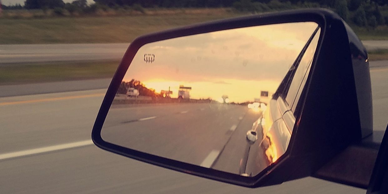 Rear-view mirror showing the journey of life's travels.