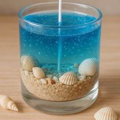 A blue candle with a white wick in a glass container.