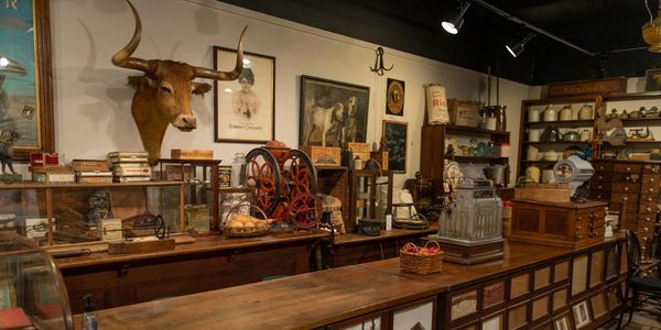 Old-fashioned general store interior with wooden counters and vintage items.