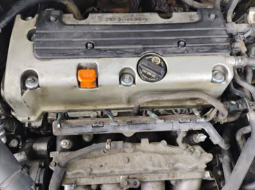 Close-up of an engine with visible oil cap and components.