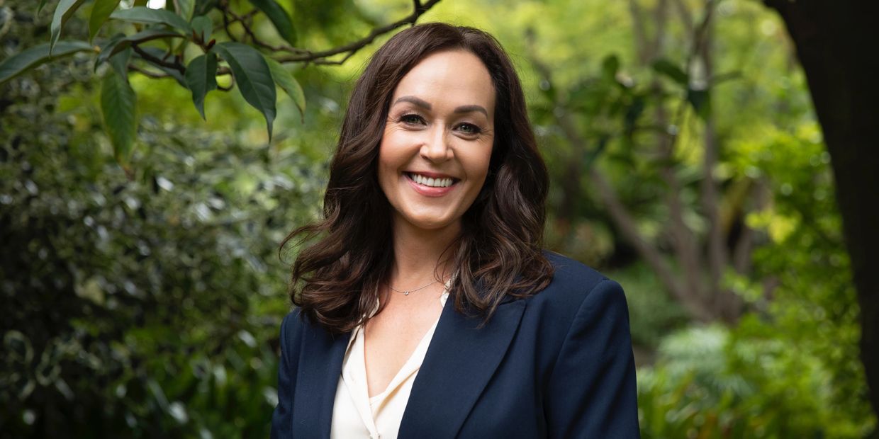 Wellness Valeria Headshot surrounded by greenery