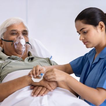 Nurse taking care of elder patient on oxygen support.