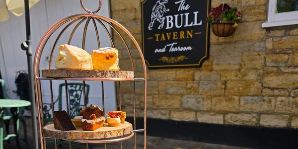 Cream tea scones and cakes on tiered display outside at The Bull Tavern and Tearoom.