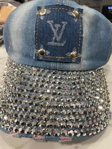 Denim cap with Louis Vuitton patch and rhinestone-covered brim.