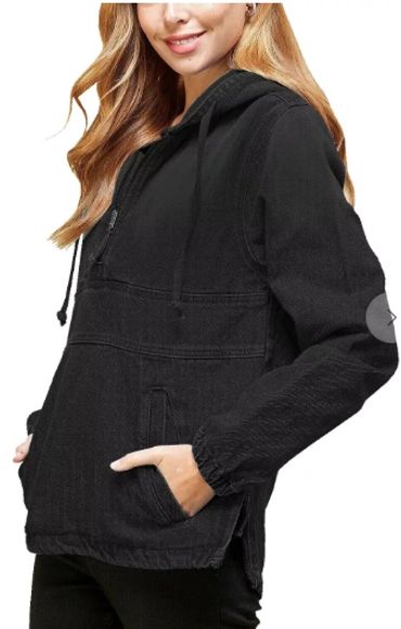 Woman wearing a black hooded jacket.