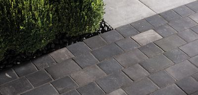 Multi Size Porcelain Pavers installed in an alternating pattern on a driveway floor