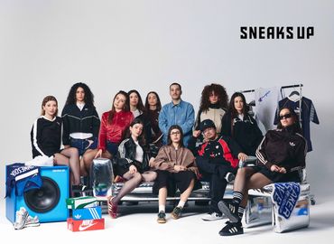 A diverse group of young adults posing with sneakers and sportswear in a studio setting.
