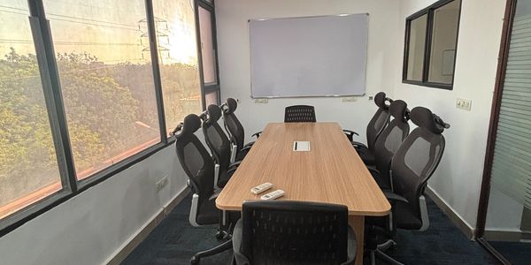 Modern conference room with large windows and ergonomic chairs.