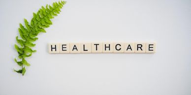 Ivory plastic letter squares lined up to form the word healthcare