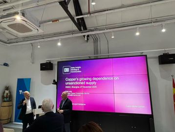 Presentation on copper's supply dependence at an event.