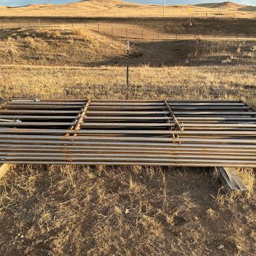 We have steel gates, continuous fence, free standing fence, & portable corral panels