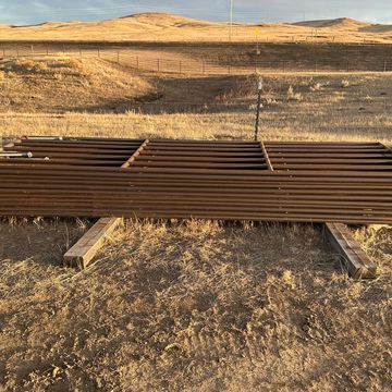 We have steel gates, continuous fence, free standing fence, & portable corral panels