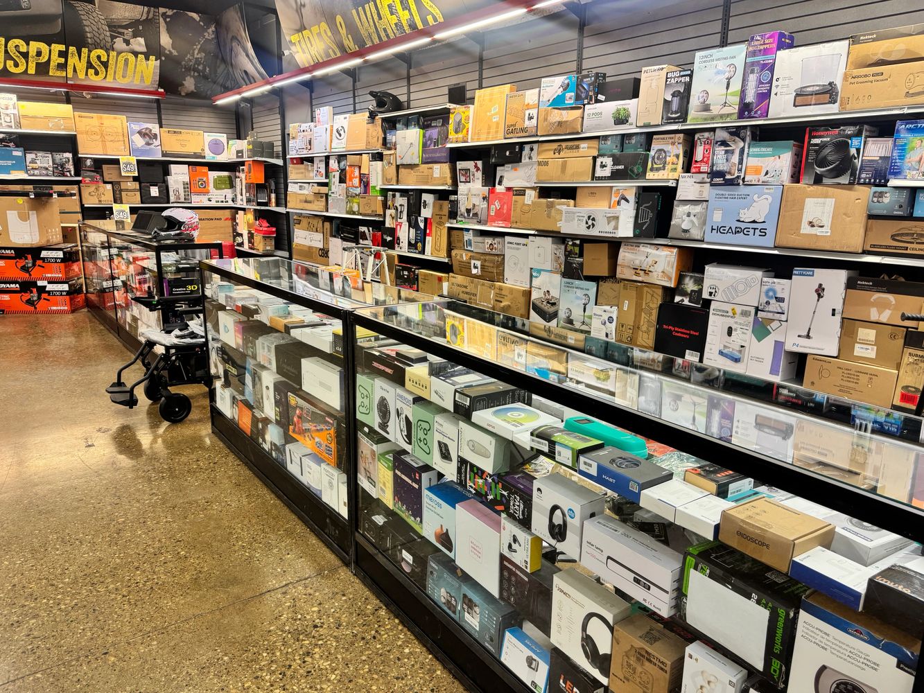 Stack of books next to pencils in a holder and a camera.
