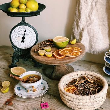 Dried limes and dried oranges and a cup of fruit tea