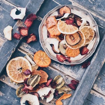 Plate of dried fruit slices on a rustic surface.