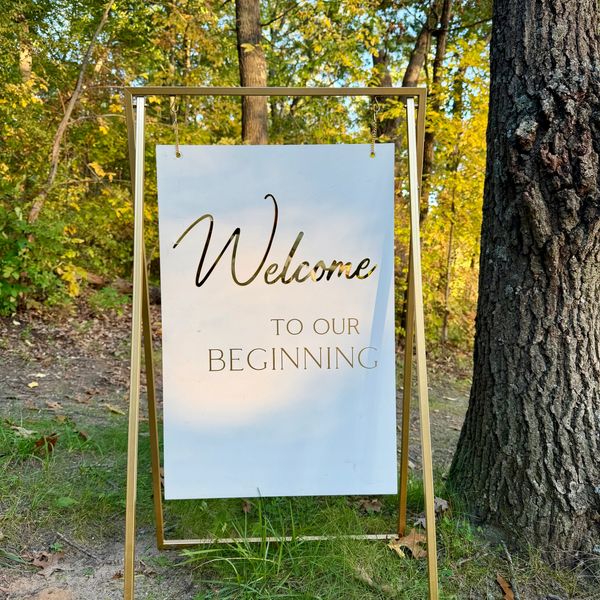 Signboard reading 'Welcome to our Beginning' outdoors.