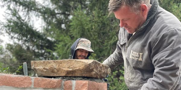Eric Sahs and employee laying stone caps in Denver, CO