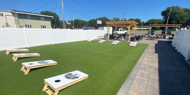 A photo of our new cornhole lanes on our new patio.