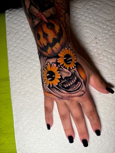 Art the clown hand tattoo done by Robert Smith at fates tattoo in Pensacola Fl 