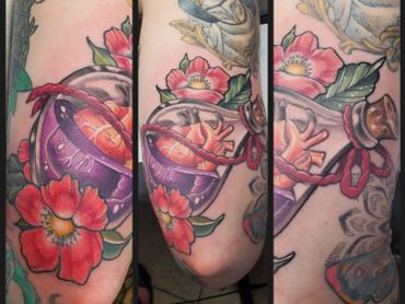 Colorful tattoo with flowers and potion bottles.
