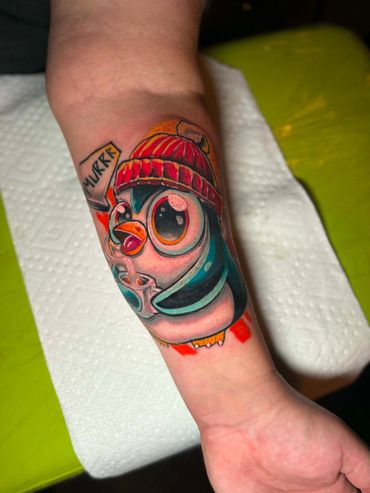 New school penguins tattoo done by Robert Smith in Pensacola Fl at Fates tattoo 
