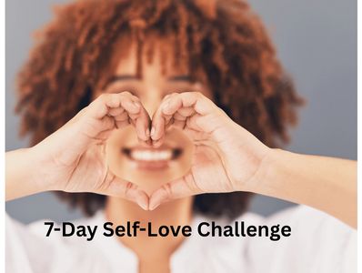 A woman with red hair, smiling, making a heart formation with her hands.