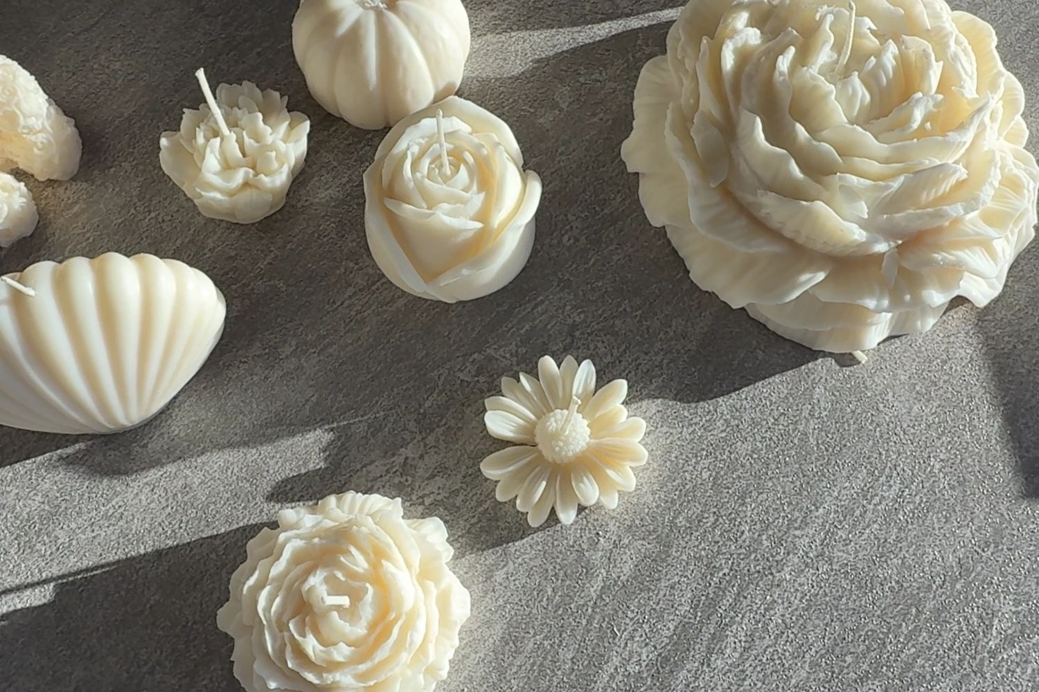 Stack of books next to pencils in a holder and a camera.